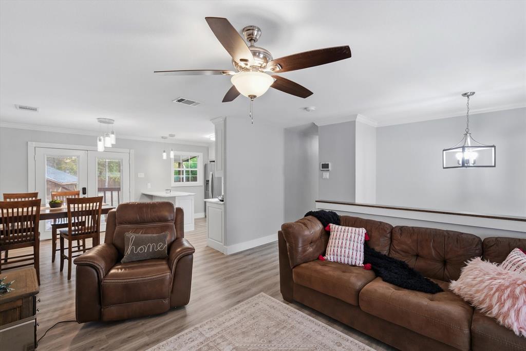 2422 Old Omen Road Tyler, TX 75701 - Photo 14 of 39 a living room with furniture ceiling fan and a rug