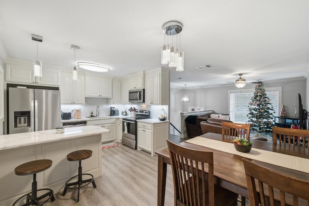 2422 Old Omen Road Tyler, TX 75701 - Photo 19 of 39 a large kitchen with a table and chairs