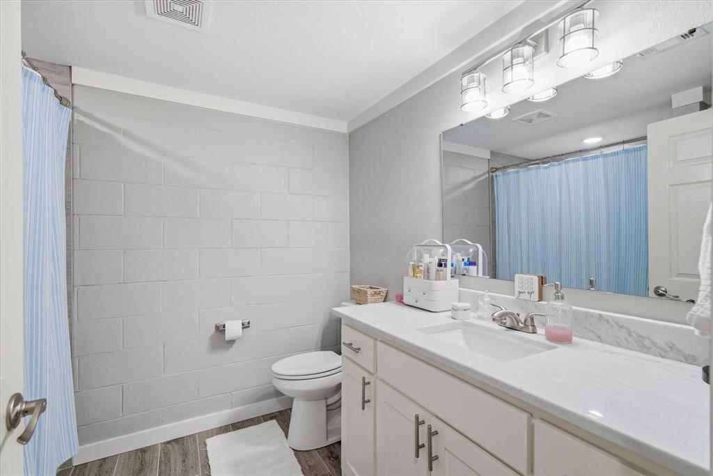 2422 Old Omen Road Tyler, TX 75701 - Photo 25 of 39 a bathroom with a sink a toilet and mirror