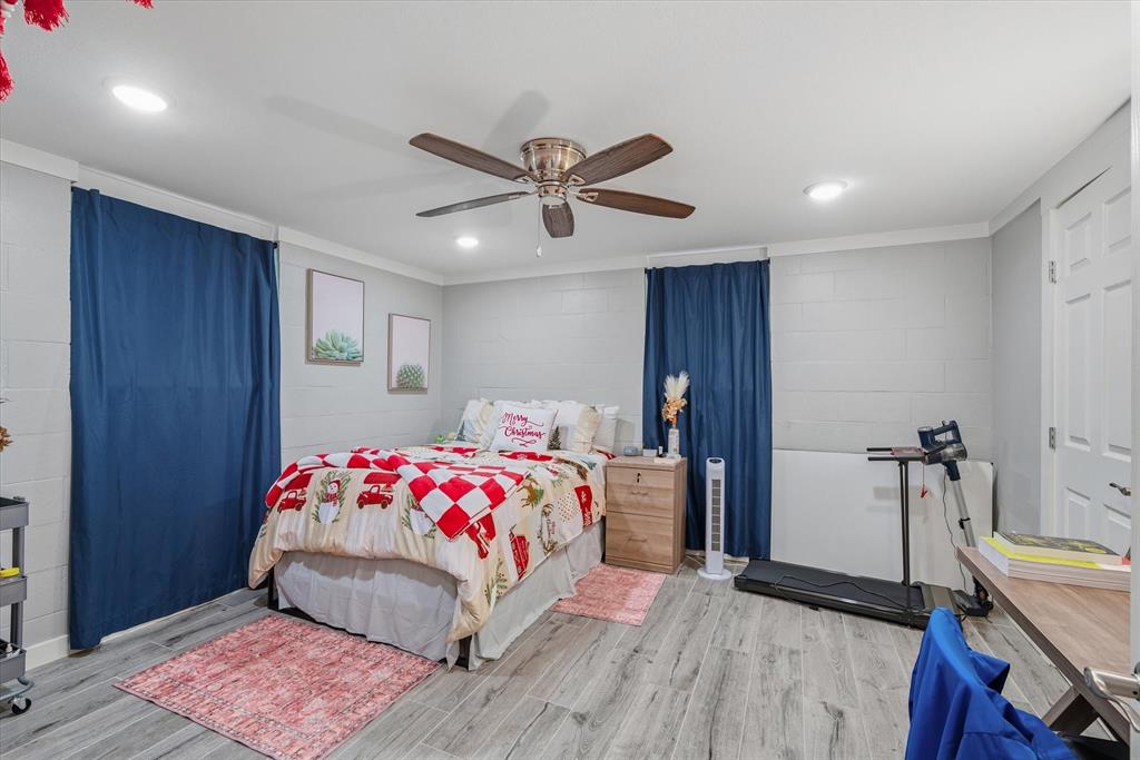 2422 Old Omen Road Tyler, TX 75701 - Photo 26 of 39 a bedroom with a bed and a chandelier