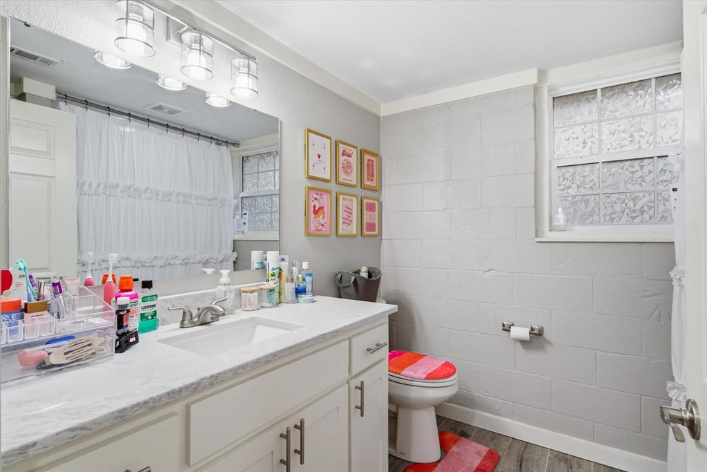 2422 Old Omen Road Tyler, TX 75701 - Photo 27 of 39 a bathroom with a sink mirror vanity and toilet