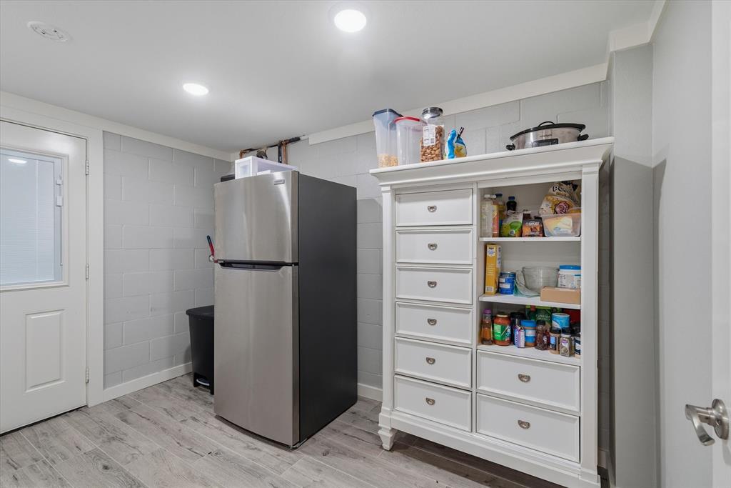 2422 Old Omen Road Tyler, TX 75701 - Photo 28 of 39 a white refrigerator freezer and a wooden floor