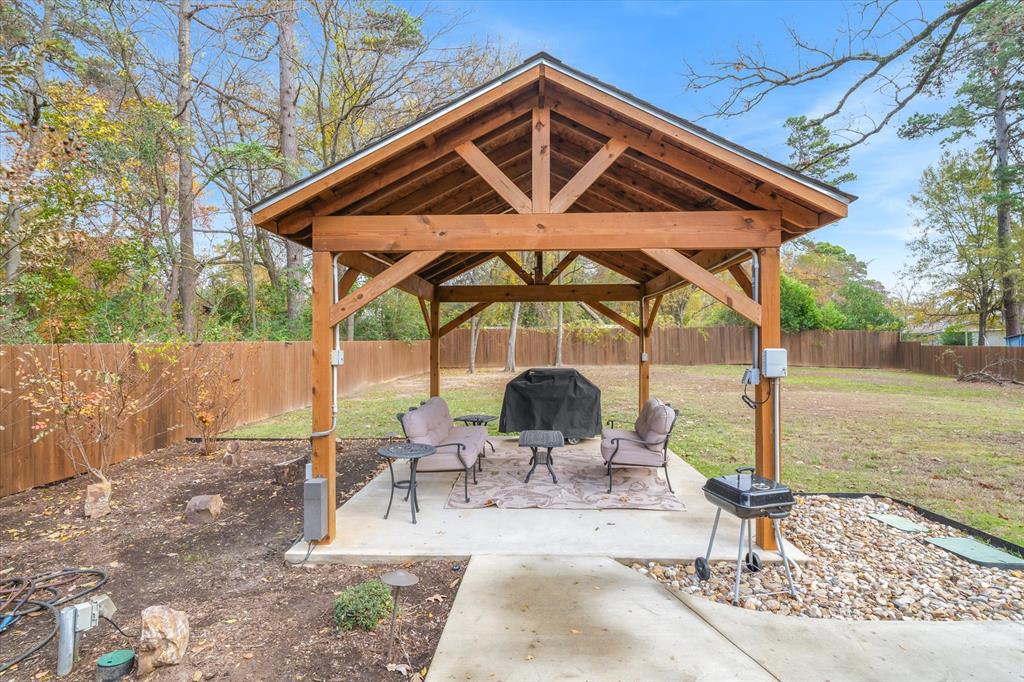 2422 Old Omen Road Tyler, TX 75701 - Photo 35 of 39 a patio with a table and chairs