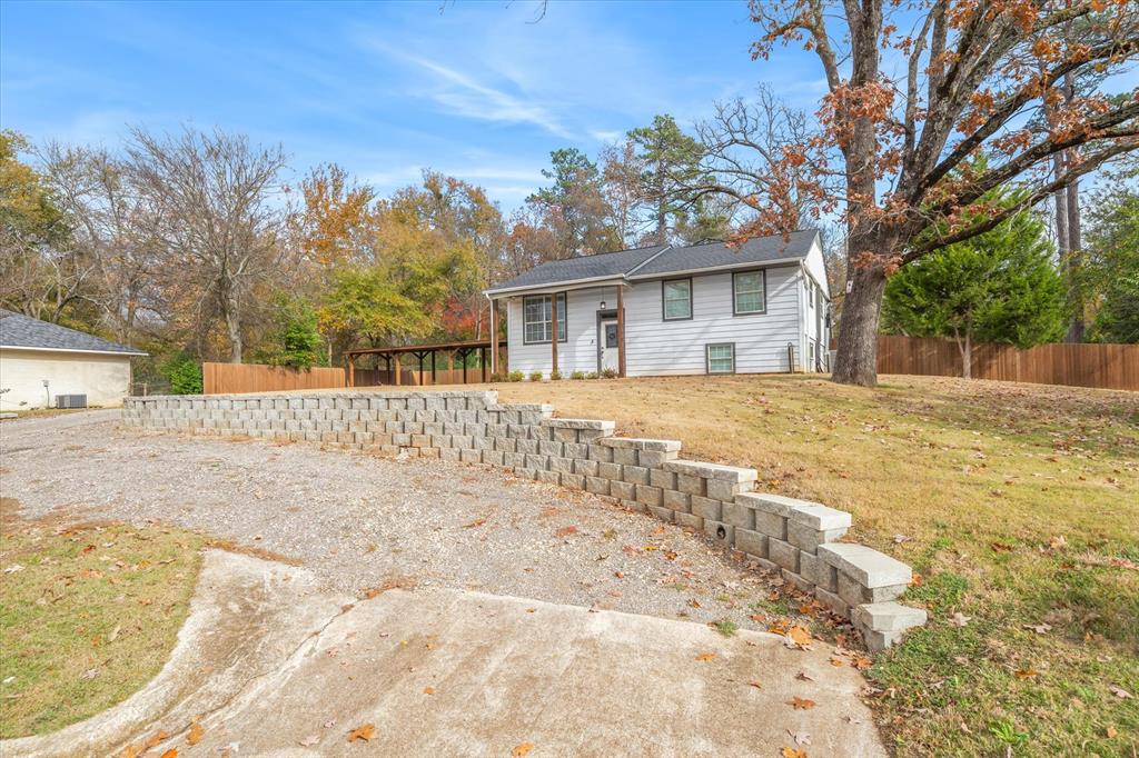 2422 Old Omen Road Tyler, TX 75701 - Photo 7 of 39 a view of a house with a yard