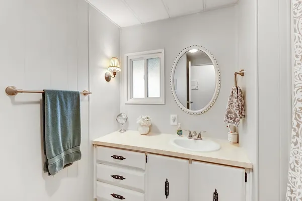 a bathroom with a sink vanity and a mirror