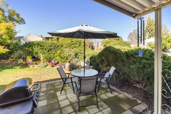 a view of a backyard with sitting area