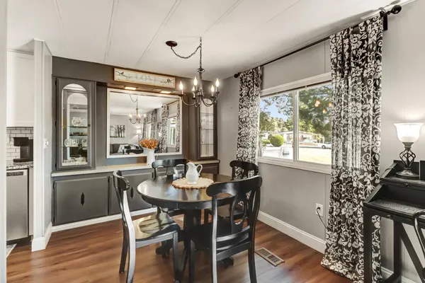 a view of a dining room with furniture window and wooden floor