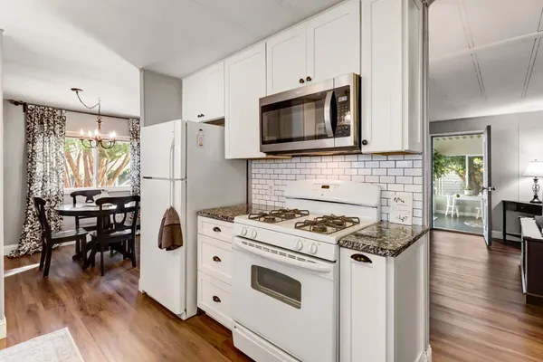 a kitchen with a stove a microwave and a refrigerator
