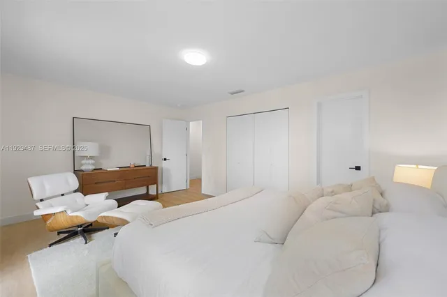 a bedroom with a bed and chair