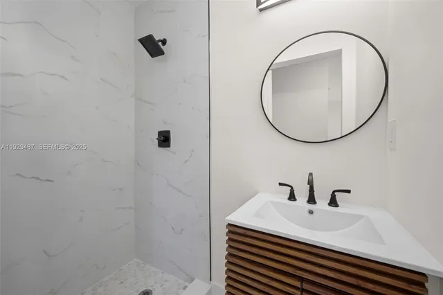 a bathroom with a sink a mirror and shower
