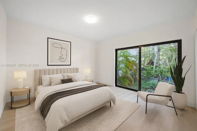 a bedroom with a bed and a large window