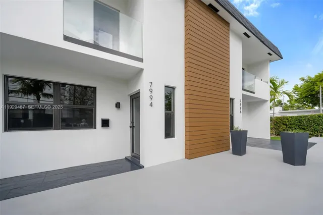 a view of a street with potted plants