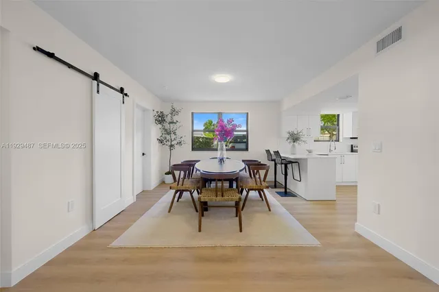 a living room with furniture a rug and a table