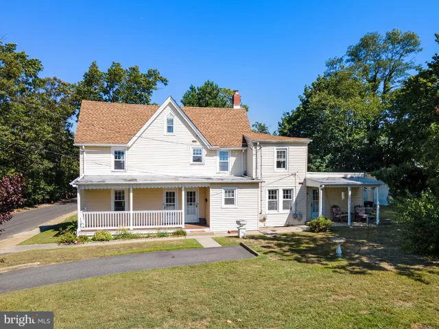 an aerial view of a house with a garden and trees