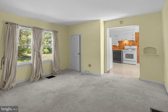 an empty room with windows and closet