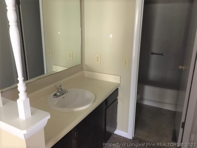 3319 Arrowhead Road Spring Lake, NC 28390 - Photo 13 of 20 a bathroom with a sink and a mirror