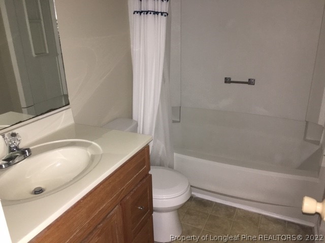 3319 Arrowhead Road Spring Lake, NC 28390 - Photo 17 of 20 a bathroom with a sink a toilet and shower