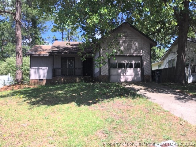 3319 Arrowhead Road Spring Lake, NC 28390 - Photo 2 of 20 a front view of a house with a yard and garage