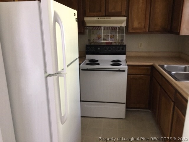 3319 Arrowhead Road Spring Lake, NC 28390 - Photo 8 of 20 a kitchen with a refrigerator and a stove
