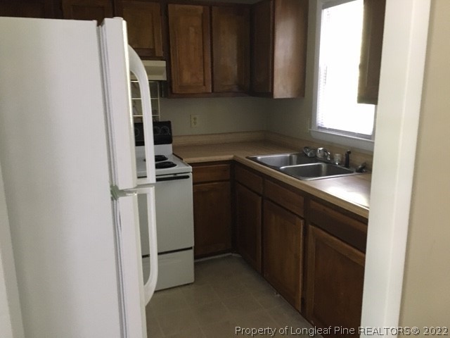 3319 Arrowhead Road Spring Lake, NC 28390 - Photo 9 of 20 a kitchen with a sink and a refrigerator