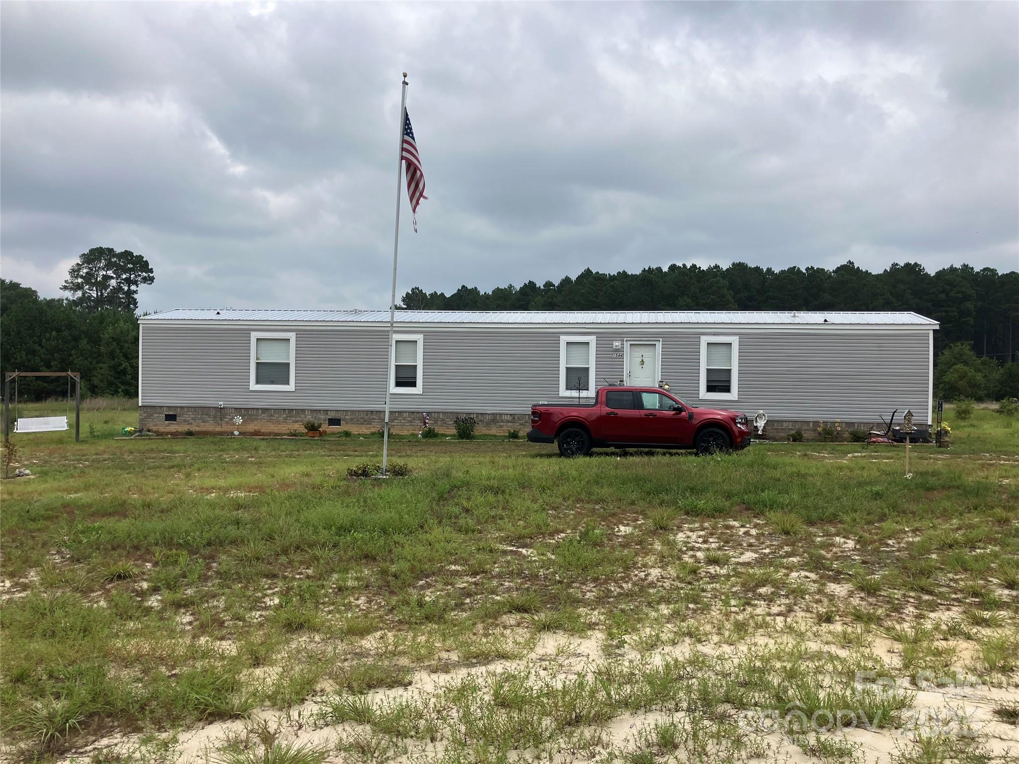 1542 Macedonia-Angelus Road Jefferson, SC 29718 - Photo 2 of 6 a view of a house with a back yard