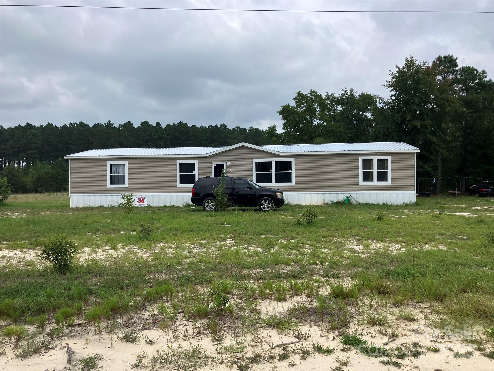 1542 Macedonia-Angelus Road Jefferson, SC 29718 - Photo 3 of 6 a view of a house with a backyard