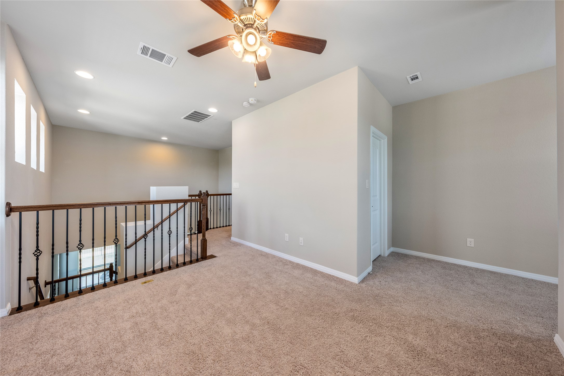 126 Rains Kyle, TX 78640 - Photo 5 of 22 Plush carpeting and an open staircase define this versatile upper-level loft area.
