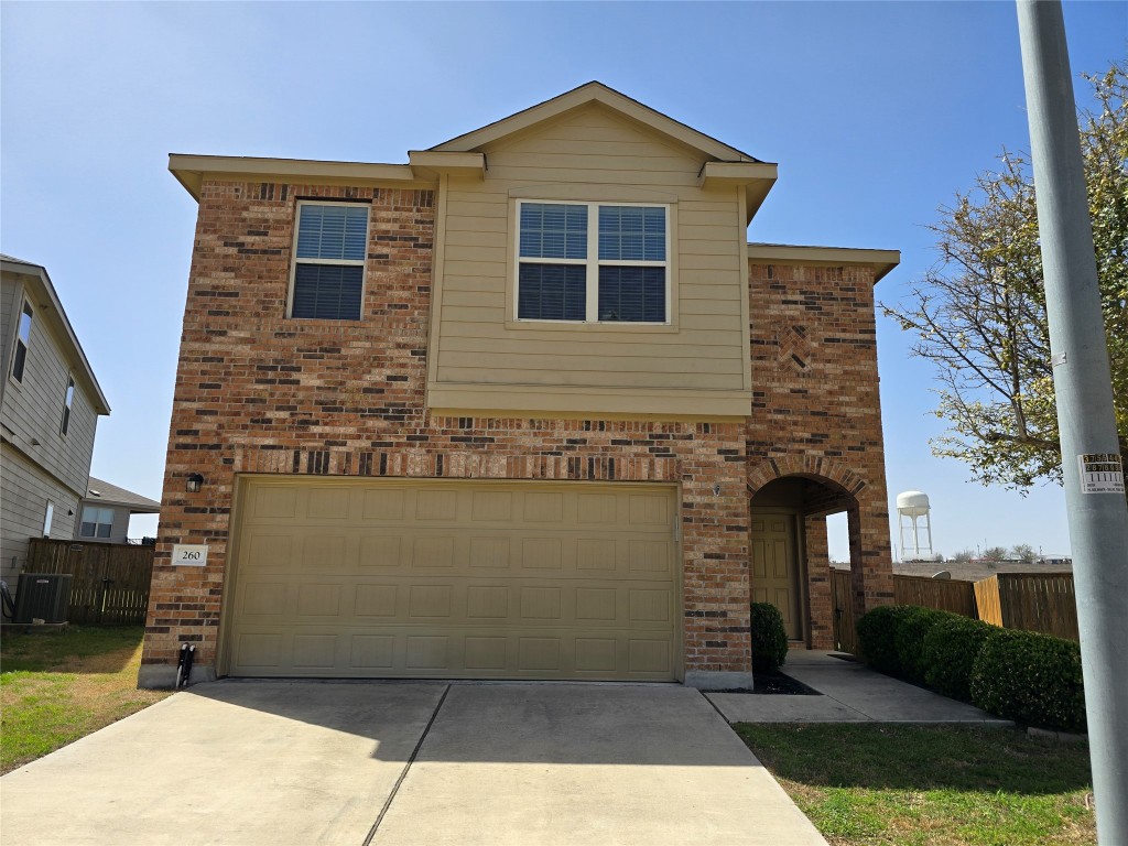 260 Circle Way, Unit 22E Jarrell, TX 76537 - Photo 1 of 14 a front view of a house with a yard