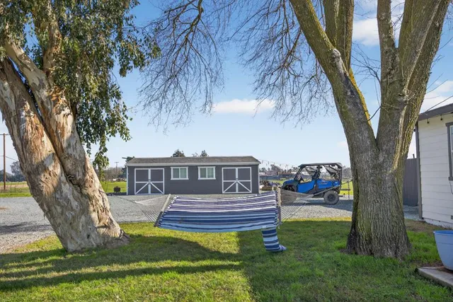 a view of a house with backyard and sitting area