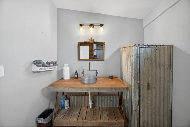 a view of a house with a yard and large trees