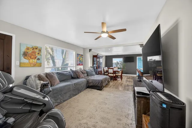 a room with furniture pool table and flat screen tv