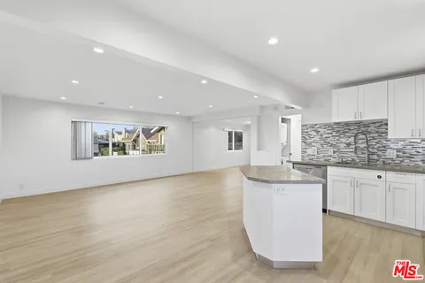 a kitchen with stainless steel appliances granite countertop a sink and cabinets
