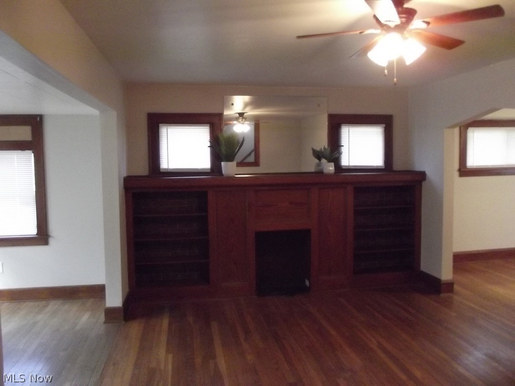 3363 Berea Road Cleveland, OH 44111 - Photo 11 of 50 Unfurnished living room with a healthy amount of sunlight, ceiling fan, and dark hardwood / wood-style flooring