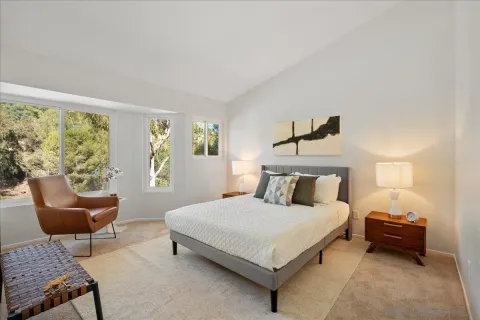 a bedroom with a bed chair and a window