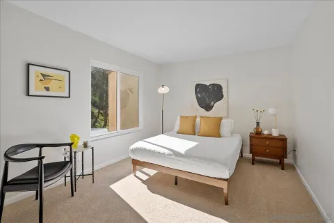 a bedroom with a bed and a table in it