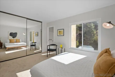 a bedroom with a large bed and a large window