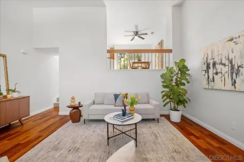 a living room with furniture and a potted plant