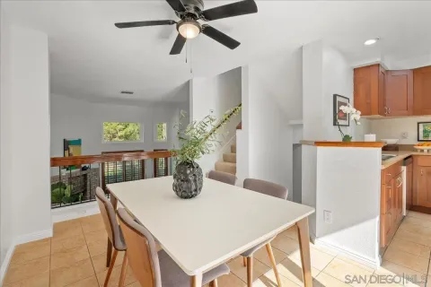 a view of a dining room with furniture and a potted plant