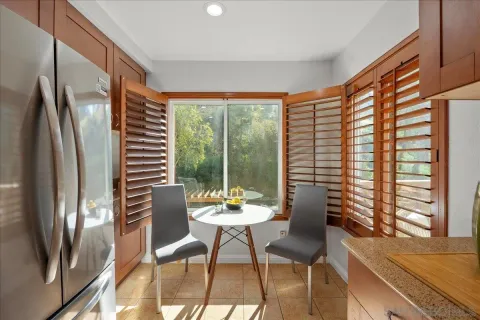a outdoor room with chairs and a large window