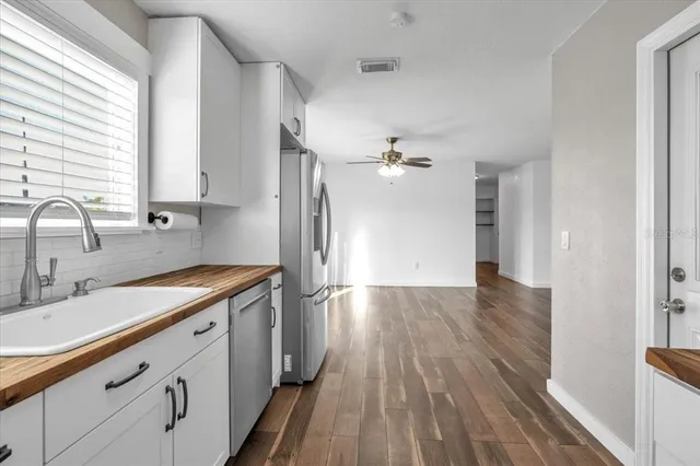 a kitchen with a sink and refrigerator