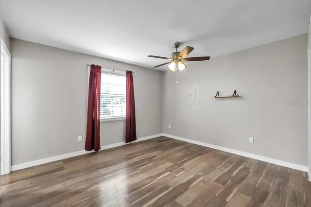 wooden floor in an empty room with a window