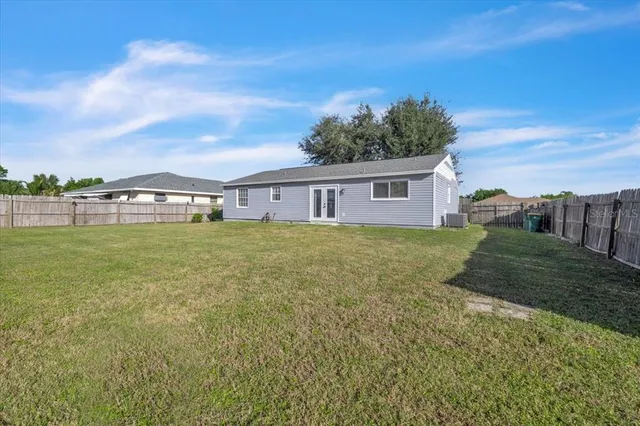 a view of a house with a yard and sitting area
