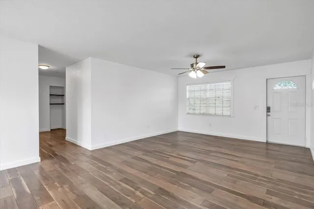 wooden floor in an empty room with a window