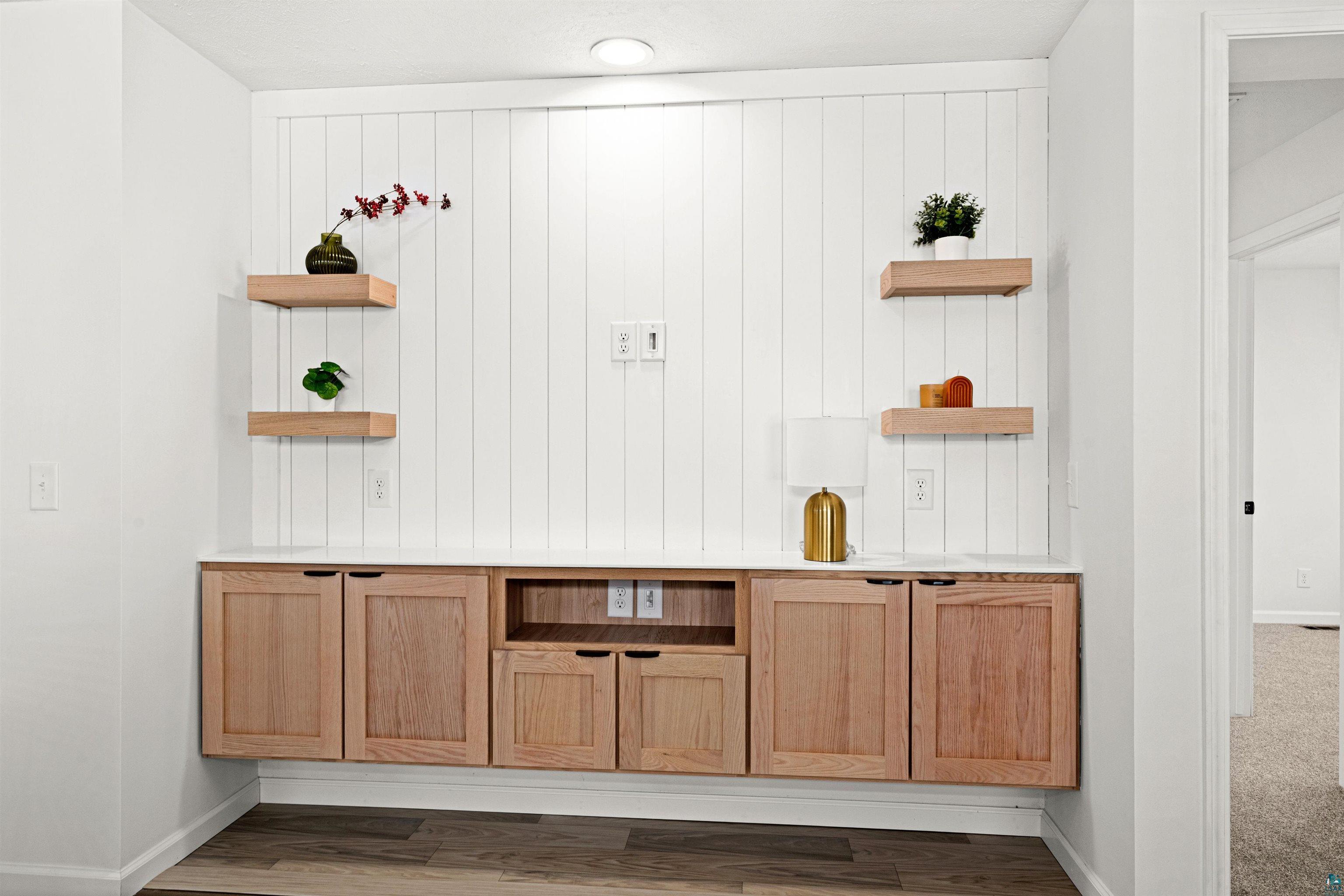 1914 East 1st Street Duluth, MN 55812 - Photo 11 of 26 Bar area featuring open shelves, light countertops, light wood finish cabinetry, vinyl flooring.