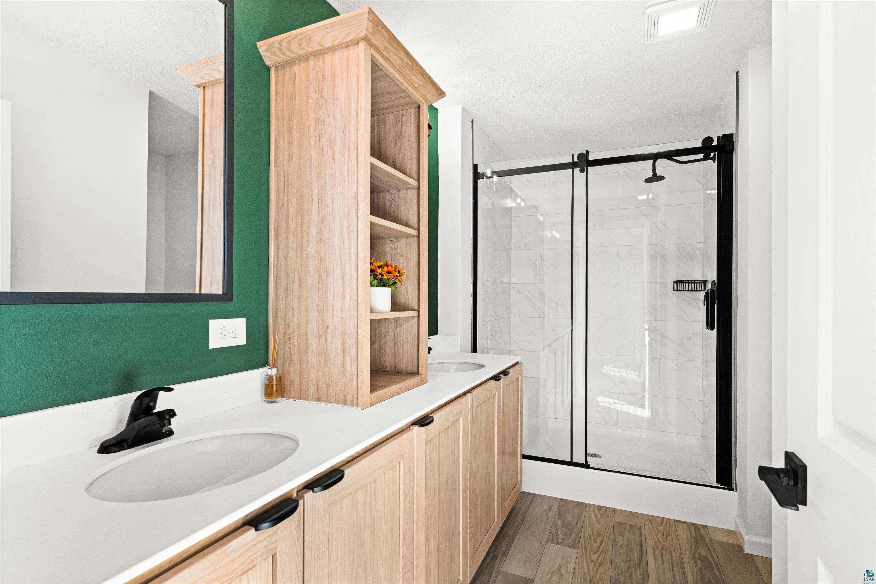 1914 East 1st Street Duluth, MN 55812 - Photo 20 of 26 Master Bathroom featuring a walk-in shower w/integrated bench & Carrara Marble pattern walls & double vanity.