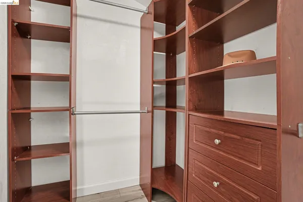 a view of walk in closet with empty racks