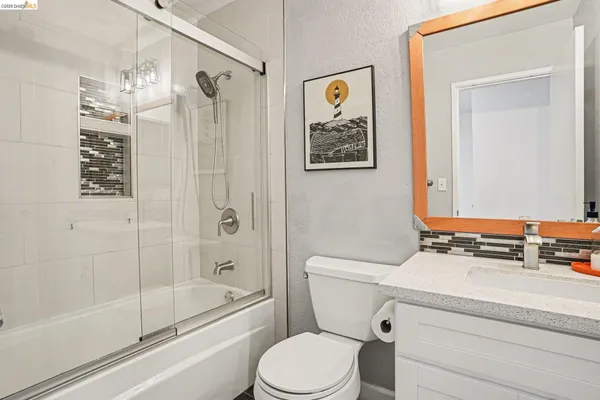 a bathroom with a toilet a sink and shower