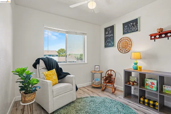 a living room with furniture and a bookshelf