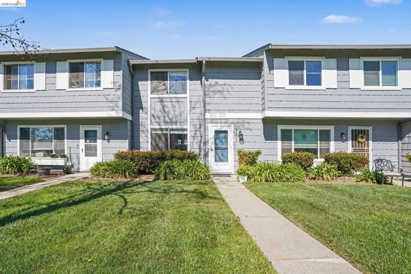 a front view of a house with garden and porch