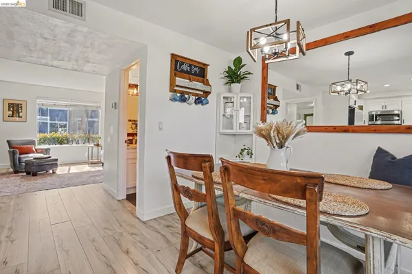 a view of a dining room with furniture and a chandelier